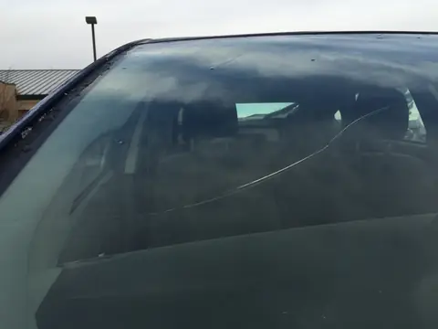 A crack running across a windshield