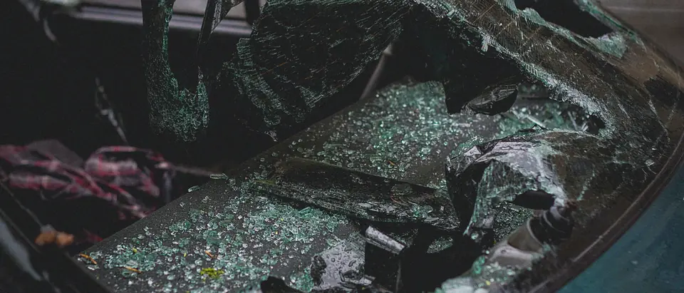 Shattered car glass with fragments across the seat