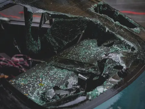 Shattered car glass with fragments across the seat